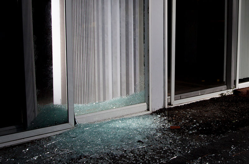 sliding glass door with broken glass